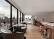 Thumbnail 11 of 20 - 2-Bedroom Apartments in White Center, WA - Elevation16 - Resident Lounge With Plenty Of Seating, A Bar Table, And Large Windows Overseeing The Outdoor Courtyard