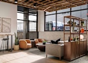 Thumbnail 12 of 20 - A room with a wooden ceiling and furniture including a sofa, chairs, and a table. at Elevation16 Apartments, Seattle, Washington