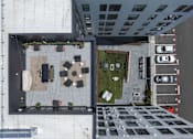 Thumbnail 12 of 24 - A top-down view of a courtyard surrounded by buildings.