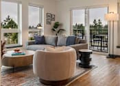 Thumbnail 18 of 20 - A modern living room with a large sectional sofa and a coffee table at Elevation16