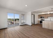 Thumbnail 9 of 20 - an open living room with a balcony and a kitchen at Elevation16 Apartments, Washington