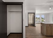 Thumbnail 6 of 20 - a view from the kitchen into the living room and the hallway to the bedrooms at Elevation16 Apartments, Seattle, 98146