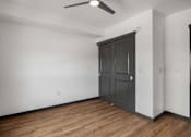 Thumbnail 8 of 20 - an empty living room with white walls and a black door at Elevation16 Apartments, Seattle