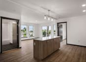 Thumbnail 7 of 20 - a large kitchen with a large island in the middle of it at Elevation16 Apartments, Seattle, Washington