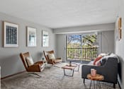 Thumbnail 26 of 28 - a living room with a couch and chairs and a window