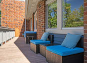 Thumbnail 20 of 28 - a porch with wicker furniture and blue cushions