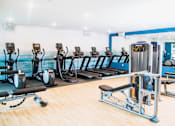 Thumbnail 50 of 68 - Vibrant fitness center within the apartment complex, equipped with modern amenities. The image captures a well-lit space filled with state-of-the-art exercise equipment, including treadmills, elliptical machines, and an array of free weights.