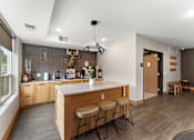 Thumbnail 46 of 68 - A kitchen with a bar stool and a counter.