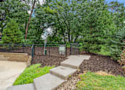 Thumbnail 68 of 68 - A park area with a sign and steps.