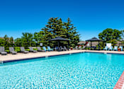Thumbnail 17 of 39 - our resort style swimming pool is surrounded by lounge chairs and umbrellas