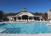 Thumbnail 9 of 25 - Pool area and Clubhouse at The Retreat at Sumter Apartments, Sumter, South Carolina
