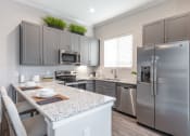 Thumbnail 3 of 11 - Gourmet Kitchen with Island at Avilla Lakeridge, Arlington, TX 76002