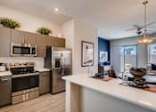Thumbnail 8 of 15 - Fully Equipped Kitchen With Modern Appliances at Avilla Centerra Crossings, Goodyear, AZ, 85338