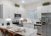 Thumbnail 8 of 12 - Gourmet Kitchen with Island at Avilla Grove, Prosper, TX 75078