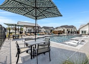 Thumbnail 16 of 19 - Resort-style pool and lounging at Avilla Oakridge in Forney, TX.