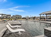 Thumbnail 2 of 19 - Resort-style pool and lounging at Avilla Oakridge in Forney, TX.