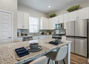 Thumbnail 2 of 12 - Gourmet Kitchen with Island at Avilla Cypress Creek, Sun City Center, FL 33573