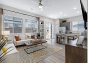 Thumbnail 4 of 8 - Living Room with Kitchen View at Avilla Traditions, Grand Prairie, TX 75052
