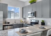 Thumbnail 6 of 11 - Gourmet Kitchen with Island at Avilla Vista Ranch, Liberty Hill, TX 78628