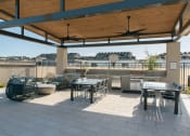 Thumbnail 8 of 9 - Outdoor Lounge + Grill Area at Avilla Broadway, Phoenix, AZ 85353