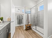Thumbnail 9 of 19 - Primary bathroom with spacious walk-in closet and premium finishes at Avilla Lakeridge in Arlington 75002.