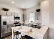 Thumbnail 9 of 13 - Fitted Kitchen With Island Dining at Avilla Buffalo Run, Colorado, 80022