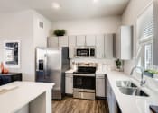Thumbnail 10 of 13 - Fully Equipped Kitchen With Modern Appliances at Avilla Buffalo Run, Commerce City, Colorado