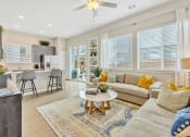 Thumbnail 8 of 14 - a living room with a couch and a table at Avilla Towne Center Apartments, Texas