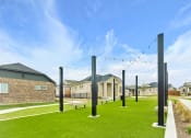Thumbnail 14 of 14 - a group of poles in a yard with houses in the background at Avilla Towne Center Apartments, Texas, 75407