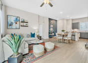 Thumbnail 10 of 14 - a living room and dining room with a couch and a table at Avilla Towne Center Apartments, Texas