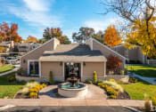 Thumbnail 7 of 32 - a house with a fountain in front of it