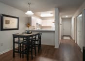 Thumbnail 10 of 31 - a kitchen and a dining room with a table and chairs at The Fountains Apartments, Pensacola, 32514