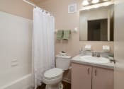 Thumbnail 27 of 31 - a bathroom with a shower and a toilet and a sink at The Fountains Apartments, Pensacola, 32514