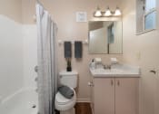 Thumbnail 21 of 31 - a bathroom with a shower toilet and sink and a mirror at The Fountains Apartments, Pensacola, 32514