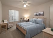 Thumbnail 19 of 31 - a bedroom with a large bed and a ceiling fan at The Fountains Apartments, Pensacola, FL