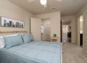 Thumbnail 22 of 31 - a bedroom with a bed and a closet and a ceiling fan at The Fountains Apartments, Pensacola, FL