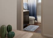 Thumbnail 23 of 31 - a bathroom with a toilet and a shower and a table with two cactuses at The Fountains Apartments, Pensacola, Florida