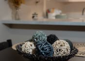 Thumbnail 13 of 31 - a bowl of balls on a table in a kitchen at The Fountains Apartments, Pensacola, 32514