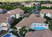 Thumbnail 9 of 31 - a aerial view of a swimming pool in a neighborhood of houses at Tivoli Apartments of Orlando, Oviedo, FL