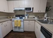 Thumbnail 21 of 31 - an empty kitchen with white cabinets and stainless steel appliances at Tivoli Apartments of Orlando, Florida, 32765