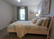 Thumbnail 26 of 31 - a bedroom with a bed and a ceiling fan at Tivoli Apartments of Orlando, Oviedo, 32765