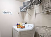 Thumbnail 31 of 31 - a walk in closet with a washer and dryer in it and a shelf at Tivoli Apartments of Orlando, Oviedo, 32765