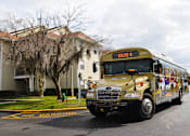 Thumbnail 12 of 31 - a school bus parked on the street in front of a house at Tivoli Apartments of Orlando, Oviedo, 32765
