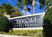Thumbnail 1 of 31 - a sign for tivoli apartments in front of palm trees at Tivoli Apartments of Orlando, Oviedo, FL