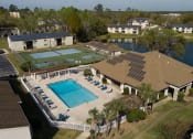 Thumbnail 4 of 39 - an aerial view of the pool and tennis court at the resort at Stoneridge Apartments, Florida, 32608