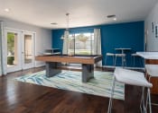 Thumbnail 14 of 39 - a game room with a pool table and a bar at Stoneridge Apartments, Gainesville, 32608