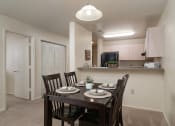 Thumbnail 29 of 39 - an open kitchen and dining room with a table and chairs at Stoneridge Apartments, Gainesville, Florida, 32608