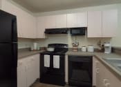 Thumbnail 26 of 39 - Fully furnished kitchen at Stoneridge Apartments, Gainesville, Florida, 32608