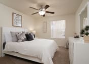 Thumbnail 36 of 39 - a bedroom with a large white bed and a ceiling fan at Stoneridge Apartments, Gainesville, FL