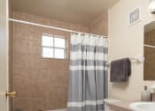 Thumbnail 38 of 39 - a bathroom with a toilet and a shower and a sink at Stoneridge Apartments, Gainesville, FL